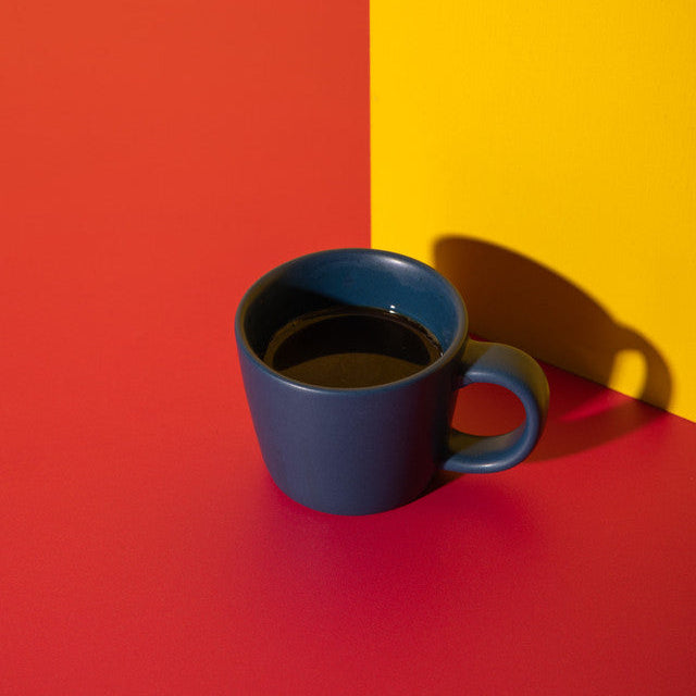Blue mug on a red and yellow background