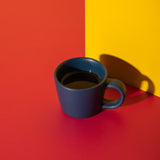 Blue mug on a red and yellow background