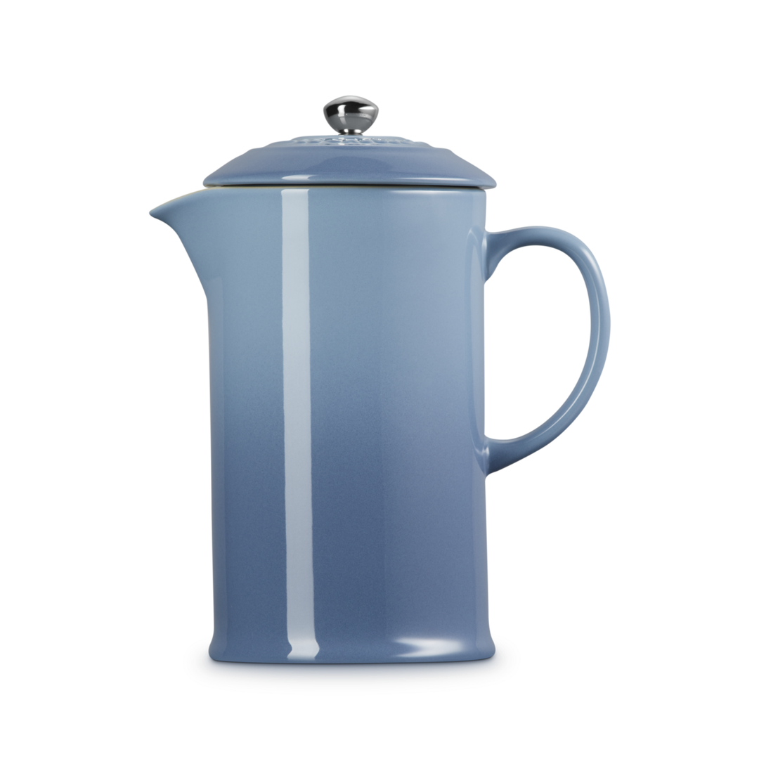 Blue French press coffee maker on a white background