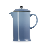 Blue French press coffee maker on a white background