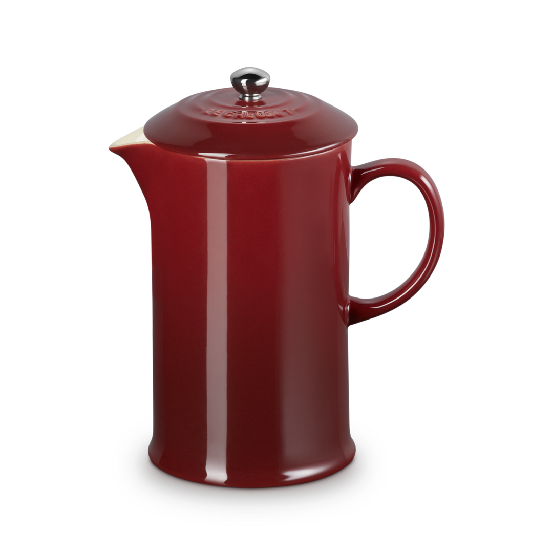 Red ceramic teapot on a white background