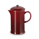 Red ceramic teapot on a white background