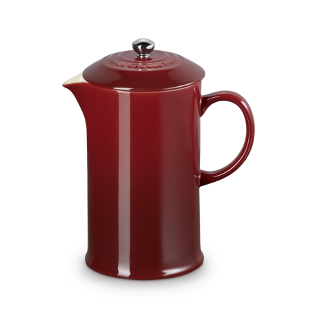 Red ceramic teapot on a white background