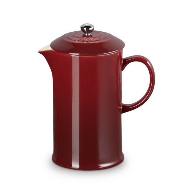 Red ceramic teapot on a white background