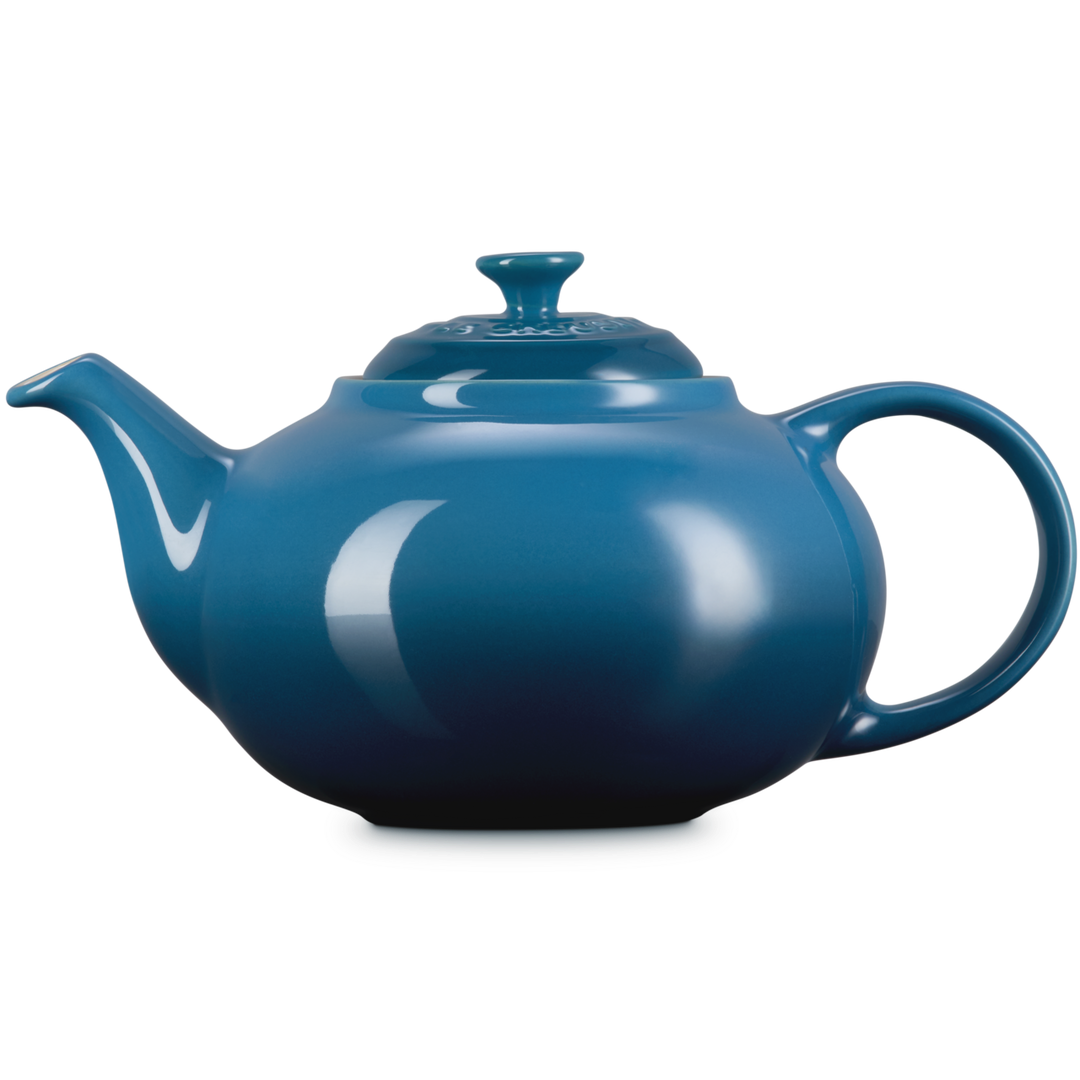 Blue teapot on a white background