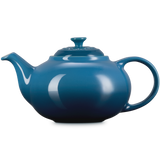 Blue teapot on a white background