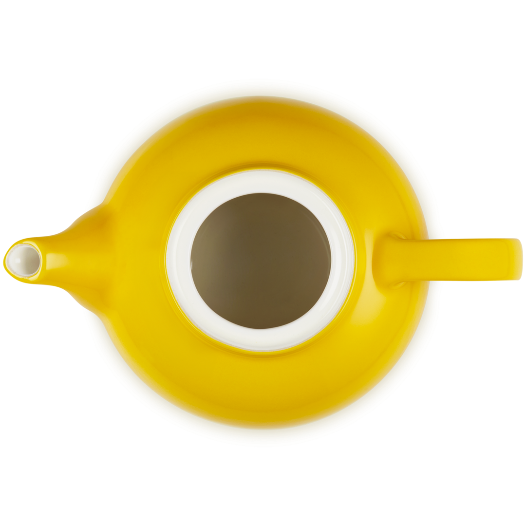 Yellow teapot with a white interior on a white background
