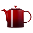 Red teapot with a white stripe on a white background