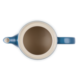 Blue and beige teapot on a white background