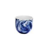 White mug with blue marbled design on a white background