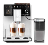 A silver Melitta LatteSelect Bean to Cup Coffee Machine with a manual two-chamber bean container, touch screen interface, and coffee dispensing area.