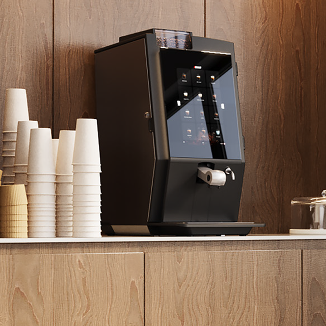 Bravilor Esprecious 21L Bean-to-Cup Coffee Machine – robust design with large 21L water tank, dual canisters for coffee beans and instant ingredients, easy-to-use touchscreen, and automatic rinsing program. Suitable for high-volume environments with up to 210 cups per day.