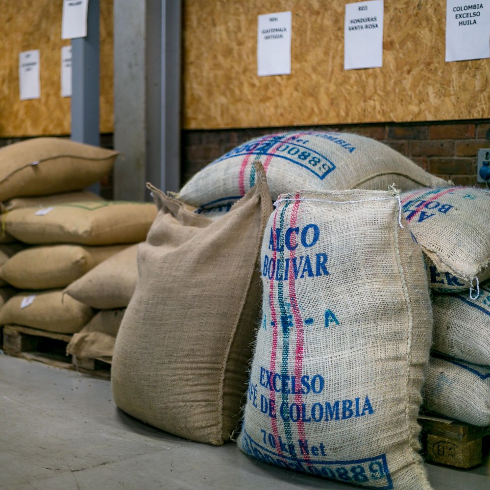 Coffee bags with visible branding in a warehouse setting