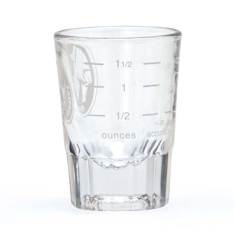 Clear glass measuring cup with etched measurements on a white background