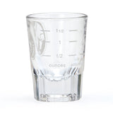 Clear glass measuring cup with etched measurements on a white background