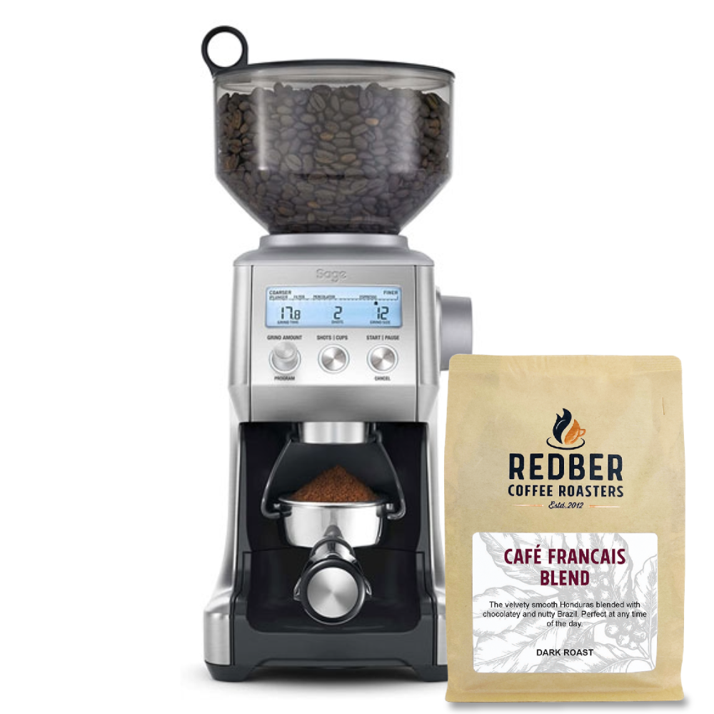Coffee grinder with a bag of Redber Coffee Roasters Cafe Francais Blend on a white background