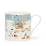 Mug with autumn-themed design featuring pumpkins, cats, and a house on a blue background.