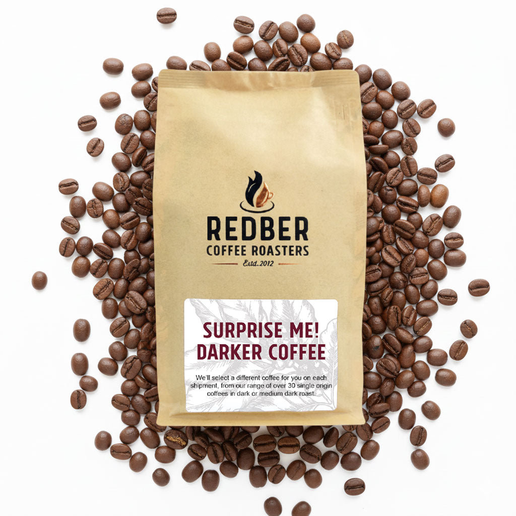 Coffee bag from Redber Coffee Roasters surrounded by coffee beans on a white background