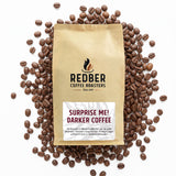 Coffee bag from Redber Coffee Roasters surrounded by coffee beans on a white background