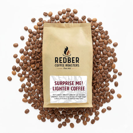 Redber Coffee Roasters package surrounded by coffee beans on a white background