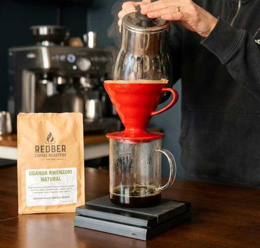 Redobr coffee roasters coffee brewing process with a red pour-over coffee maker.
