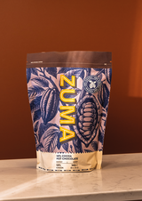 Zuma hot chocolate packaging with leaf design on a brown background