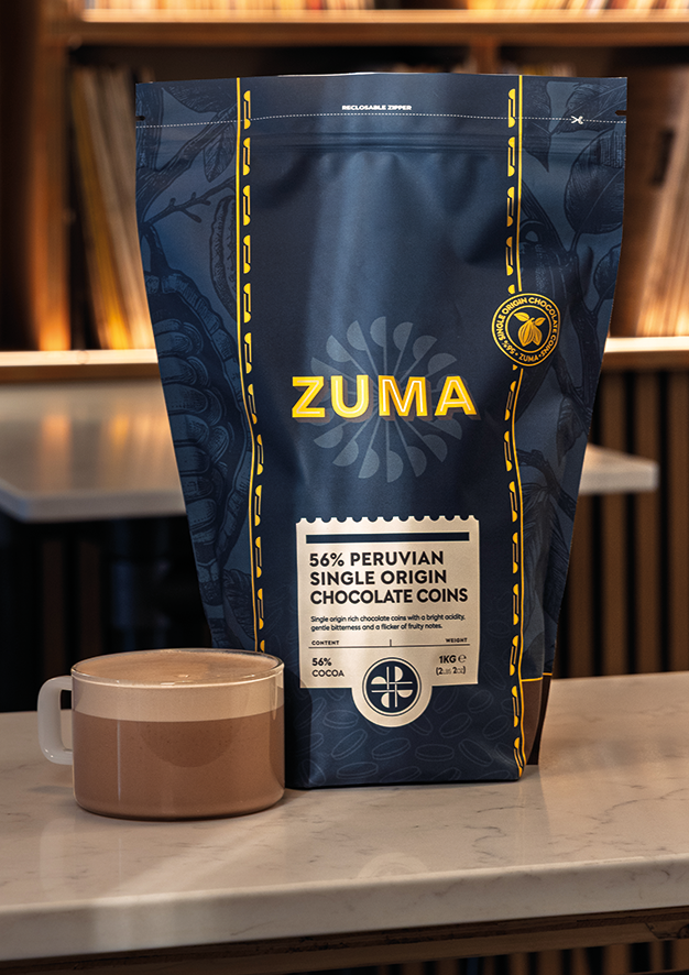 Zuma chocolate packaging with a brown mug on a table