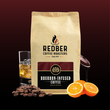 Redber Coffee Roasters bourbon-infused coffee package with coffee beans, a glass of whiskey, and oranges on a dark background.