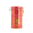 Red tin canister with gold accents on a white background
