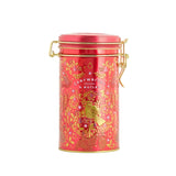 Red tin canister with gold accents on a white background