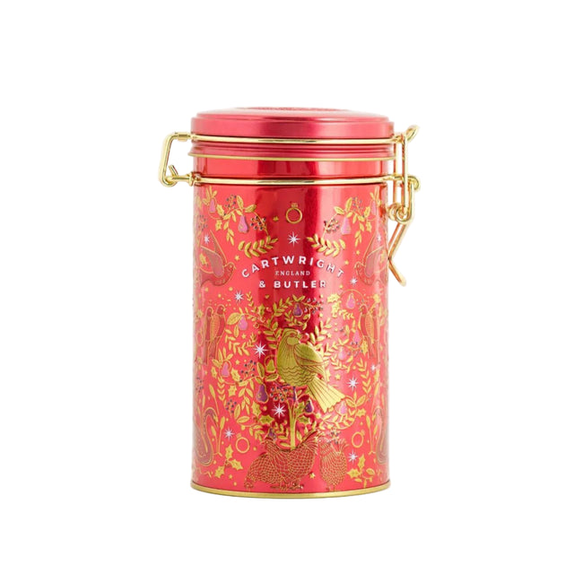 Red tin canister with gold accents on a white background