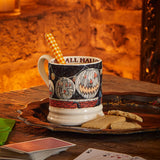 Emma Bridgewater All Hallows Eve 1/2 Pint Mug – Halloween lifestyle setting with the mug beside a fireplace