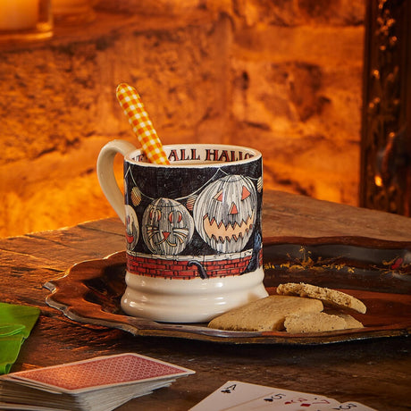 Emma Bridgewater All Hallows Eve 1/2 Pint Mug – Halloween lifestyle setting with the mug beside a fireplace