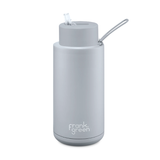 A gray ceramic reusable bottle with a stainless steel outer layer, featuring a straw lid and the Frank Green brand logo.