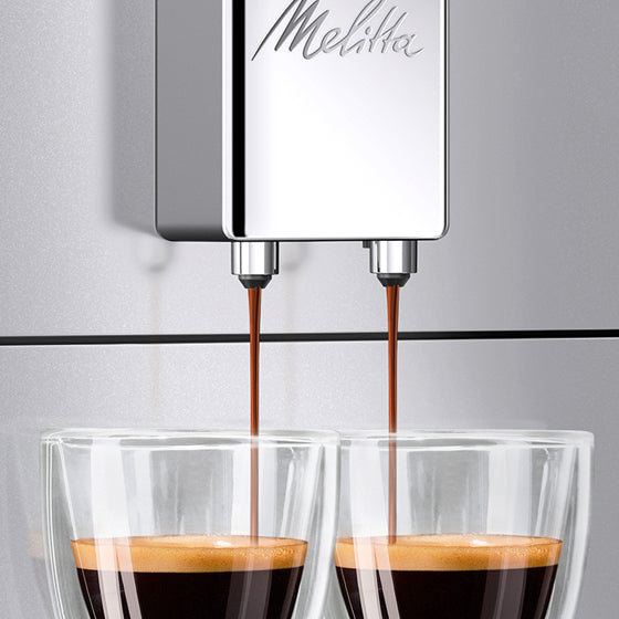 Melitta coffee machine pouring espresso into two glasses.