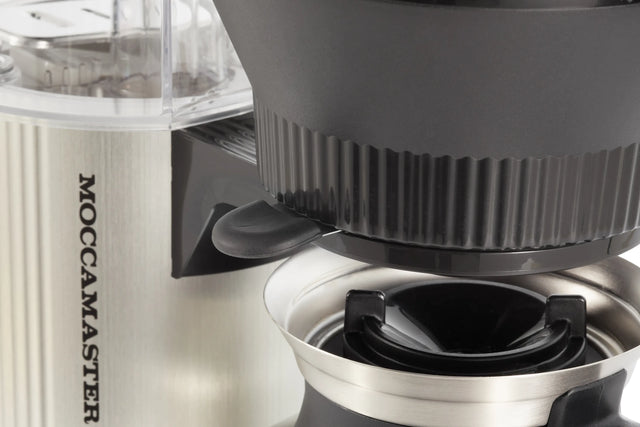 Close-up of a Moccamaster coffee grinder with a focus on the top part.
