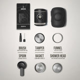 Collection of coffee brewing tools including a brush, spoon, tamper, funnel, and shower head on a light gray background.