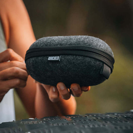 Holding the black Wacaco Minipresso GR2 travel case outdoors