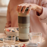Preparing coffee with a Clay Pink Wacaco Prestina at a kitchen table