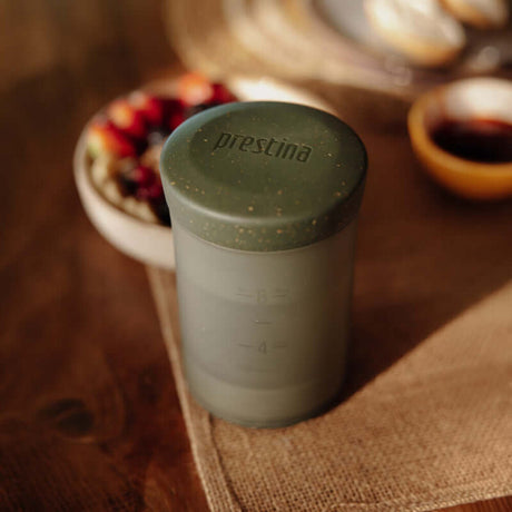 Sage Green Wacaco Prestina coffee press on a wooden breakfast table