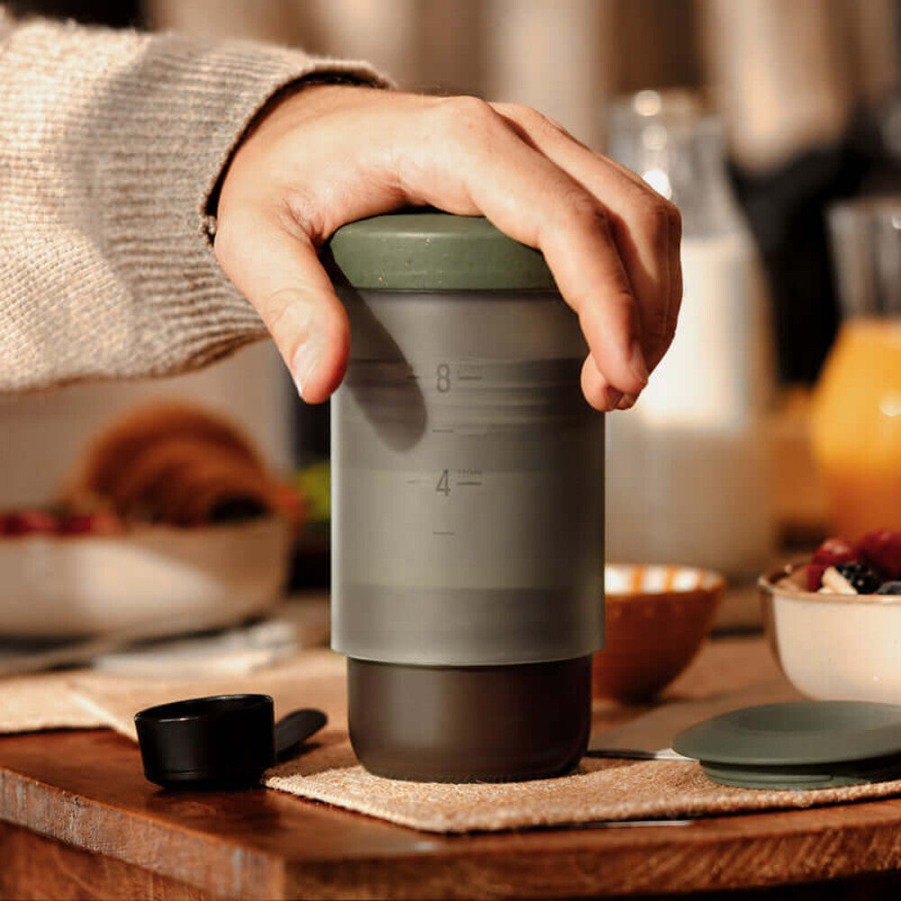 Pressing coffee with a Sage Green Wacaco Prestina at breakfast