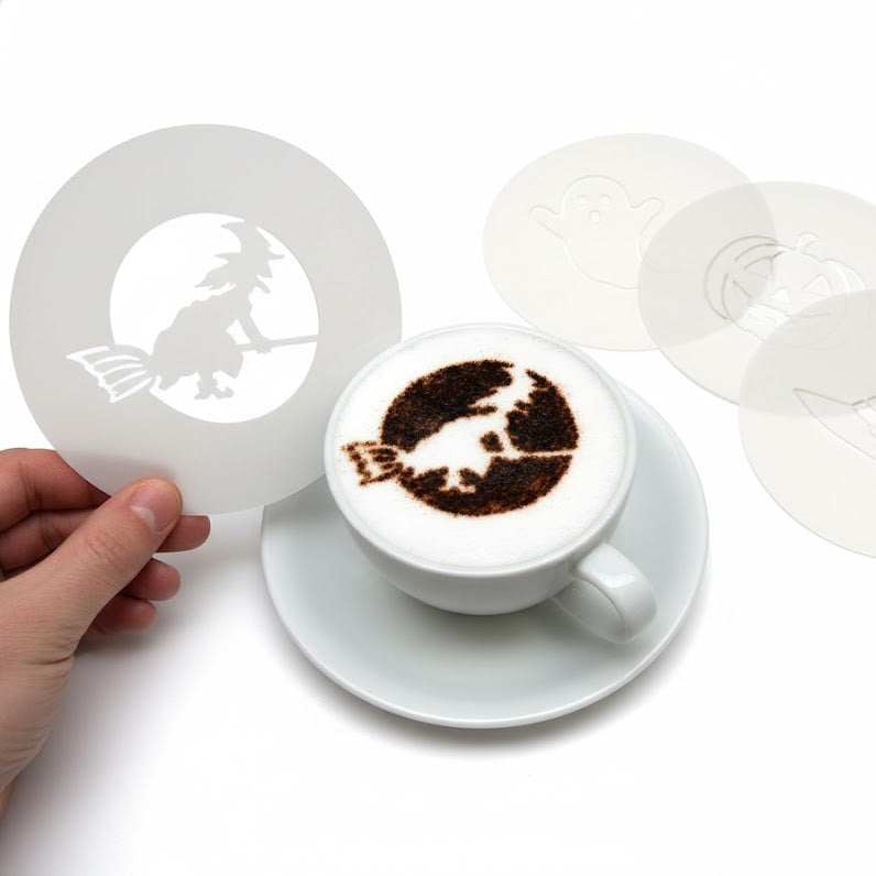 Cappuccino with latte art of a cat, surrounded by white coffee filters on a white background.